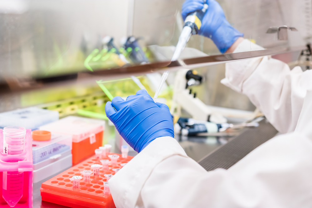 Lab tech working under fume hood