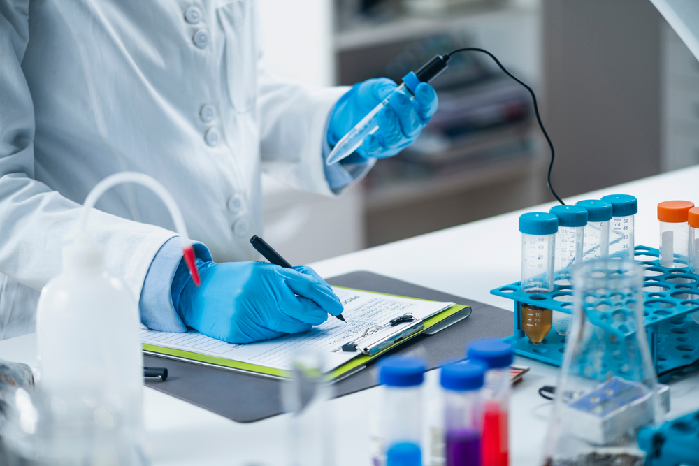 Organic agricultural product quality testing in certified laboratory. Scientist measuring pH of the sample with pH meter